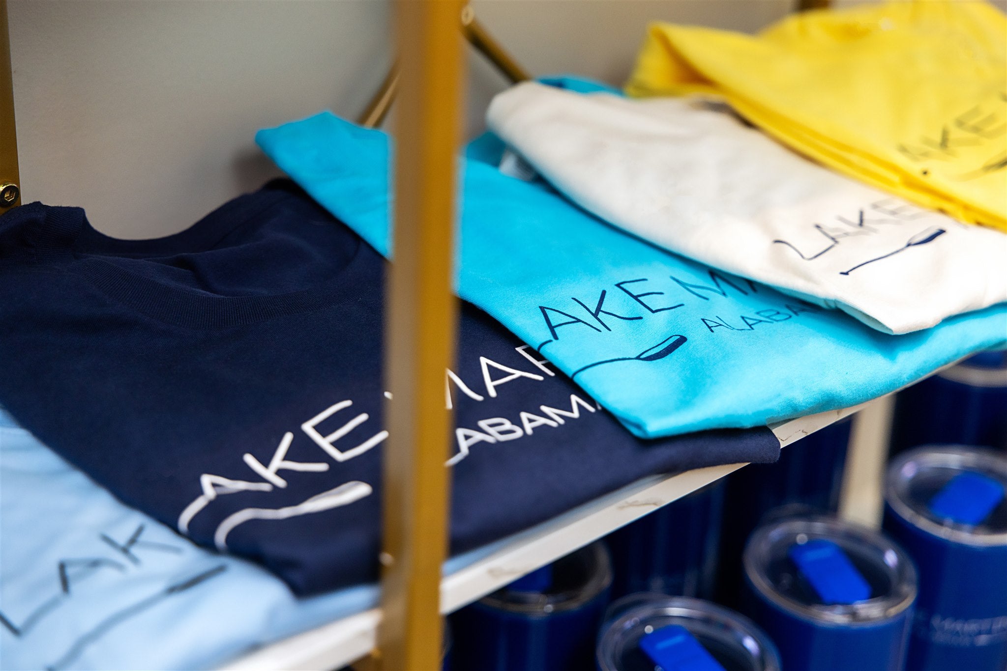 Multicolored Lakemartin shirts folded on a shelf
