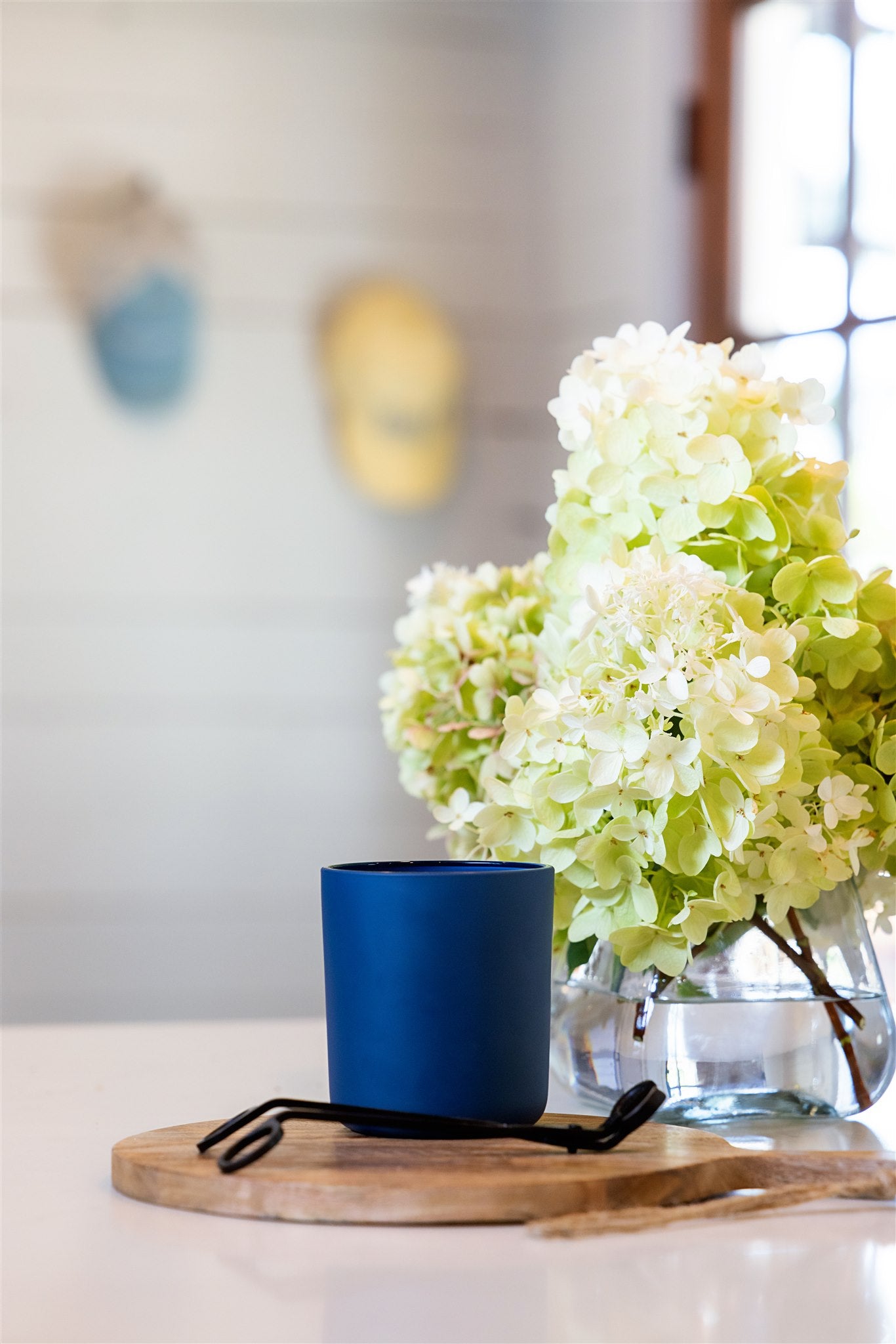 a candle with flowers on a table